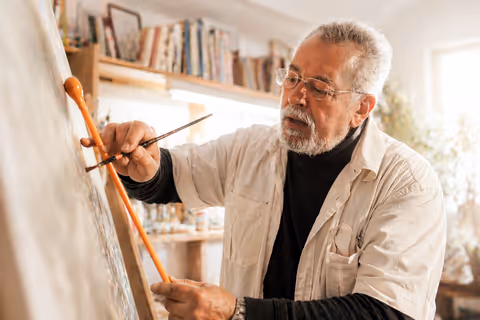 Artist working in a studio by a window